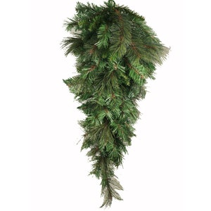 May include: A cascading, artificial evergreen garland with lush green needles and a natural, textured appearance. The garland is designed to hang, with a dense top that tapers to a lighter, feathery bottom. Ideal for holiday decor.