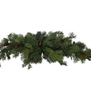 May include: A green artificial Christmas garland featuring pine needles and small brown pine cones. The garland is curved, ideal for a mantelpiece or doorway. The dense evergreen branches create a festive holiday appearance. The garland is approximately 90 cm in length.