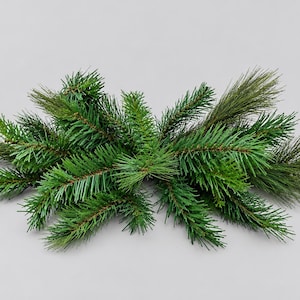 May include: A cluster of artificial evergreen branches featuring a mix of vibrant green pine needles and darker, slender needle-like foliage. The branches are arranged in a horizontal, spreading formation with realistic textures and varied shades of green.