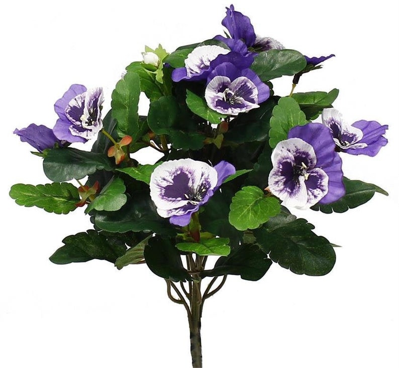 May include: A bouquet of artificial purple and white pansies with green leaves.