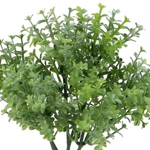 May include: A lush green artificial bush with small, delicate leaves. The bush is perfect for adding a touch of greenery to any space.