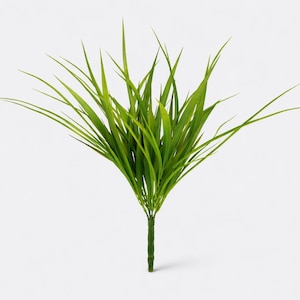 May include: A bundle of artificial green grass with long, slender blades. The grass is a vibrant green color and is arranged in a fan-like shape, with a single stem at the base. The background is plain white.