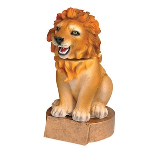 May include: A golden lion figurine with a detailed mane and a playful expression. The lion is sitting on a gold-colored base.