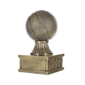May include: Gold basketball trophy with a textured basketball on top and a base with a design of basketball players.