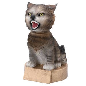 May include: A gray and brown bobblehead figurine of a cat with its mouth open in a roar. The cat is sitting on a brown base.