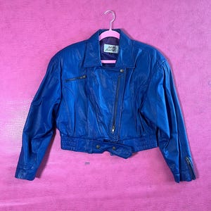 Vintage 80s "Out Of Bounds" Blue Leather Jacket - Fits Up To Size M