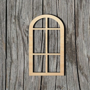 May include: A wooden cutout of an arched window with six panes. The window is light brown and has a rustic woodgrain texture. The window is against a backdrop of weathered wood.