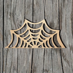 May include: A wooden cutout of a spider web, perfect for Halloween decorations. The web is intricately detailed and has a natural wood finish.