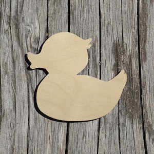 May include: A wooden cutout of a duck in the shape of a rubber ducky. The cutout is unpainted and has a smooth, natural wood finish.