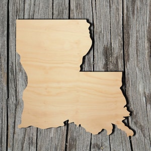May include: A wooden cutout of the state of Louisiana. The cutout is a light brown color and has a smooth, unfinished surface.