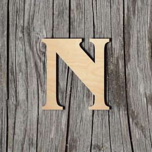 May include: A wooden letter N, painted in a natural wood color, against a rustic wood background.