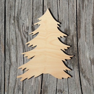 May include: A wooden cutout of a Christmas tree, with a natural wood finish. The tree is shaped like a traditional Christmas tree, with a pointed top and branches that extend out from the trunk.