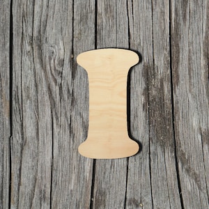 May include: A wooden letter I, cut out in a simple, classic style. The letter is light brown and has a smooth, unfinished surface. It is placed against a backdrop of weathered wood.