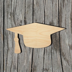 May include: A wooden cutout of a graduation cap, a traditional symbol of academic achievement.