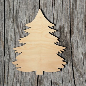 May include: A wooden cutout of a Christmas tree, painted in a light brown color, against a rustic wood background.