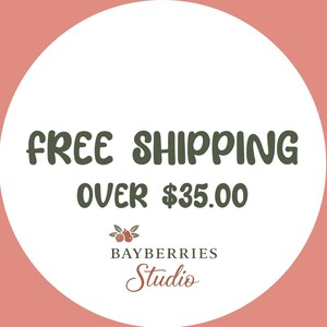 May include: A circular graphic with a dusty rose background and a large white center circle. The text reads FREE SHIPPING OVER $35.00 in dark green. Below is a small illustration of three bayberries with leaves and the text BAYBERRIES Studio.