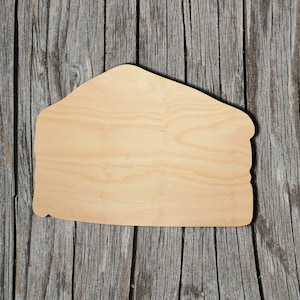 May include: A blank, unfinished wooden cutout shaped like a house. The cutout is light brown and has a smooth surface. It is sitting on a weathered wooden background.