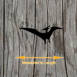 May include: A black silhouette of a pterodactyl in flight. Below the figure, a yellow double-headed arrow spans the width of the wingspan, accompanied by the orange text Measured in Length, indicating the dimension being measured.