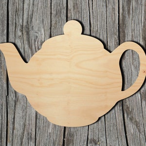 May include: A wooden cutout of a teapot, perfect for crafting and decorating. The cutout is made of natural wood and has a smooth, unfinished surface.