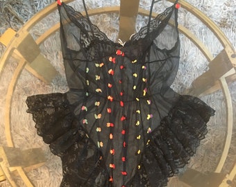 Sheer black teddy with floral appliqués