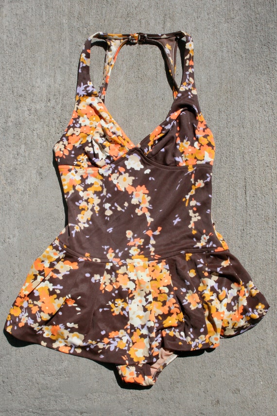 Orange and brown swimsuit with peplum.