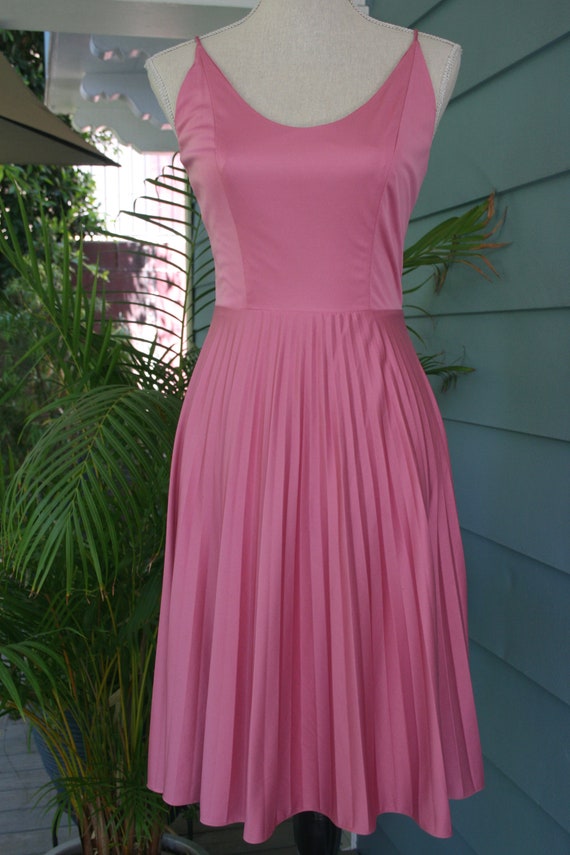 Lipstick pink 70s dress with pleated skirt.