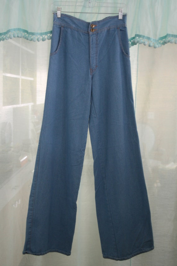 Blue 70s style wide-leg jeans.