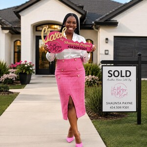 May include: A large pink prop key with gold lettering that reads Closed by Shaunta Payne 434.509.9301 and You Matzay HOMEgurl. The key is held in front of a white satin long-sleeve blouse and a high-waisted pink tweed midi skirt with gold buttons.