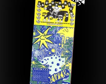 May include: A vibrant calendar with a yellow top section displaying a black and white illustration and the text "SAURUND & FRIENDS". The lower section is blue and green with a sun and a spotted creature. The month of January is shown.