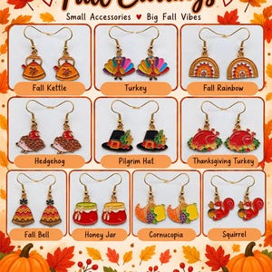 May include: A collection of gold-toned dangle earrings featuring enamel charms with autumn themes, including a kettle, turkey, rainbow, hedgehog, pilgrim hat, roasted turkey, bell, honey jar, cornucopia, and squirrel, labeled Fall Earrings.