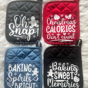 May include: Four quilted pot holders in gray, red, blue, and black. Each pot holder has a pocket and a loop for hanging. White text and graphics include phrases like "Oh Snap!" and "Christmas Calories Don't count."