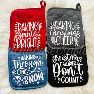 May include: Four red, gray, blue, and black oven mitts with white text. The text on the mitts reads "Baking spirits bright", "Baking Christmas cheer", "Baking through the snow", and "Christmas calories don't count".