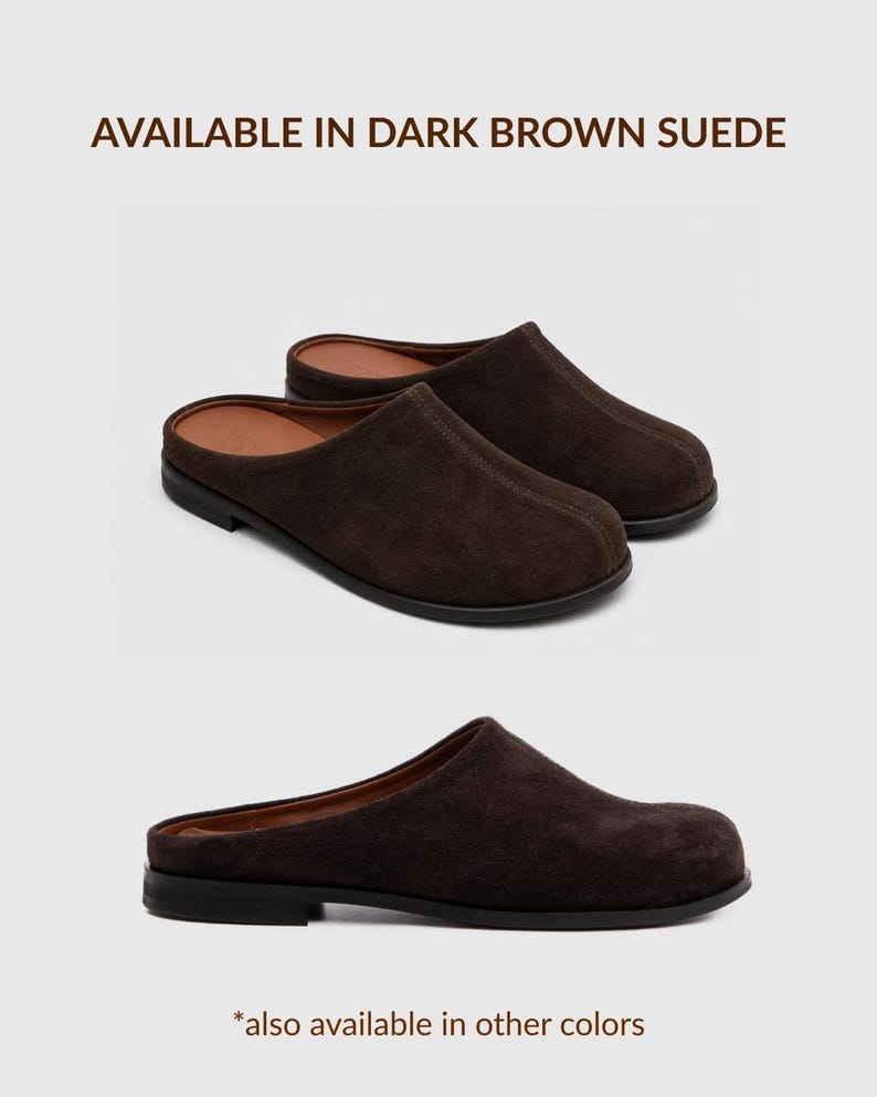 May include: A pair of dark brown suede mules with a rounded toe, a low heel, and a tan interior lining. The text at the top reads AVAILABLE IN DARK BROWN SUEDE and the text at the bottom reads *also available in other colours.