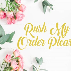 May include: A white wooden surface is adorned with pink roses and green foliage. The words "Rush My Order Please" are written in gold glitter script across the center of the image, creating a decorative and floral design.