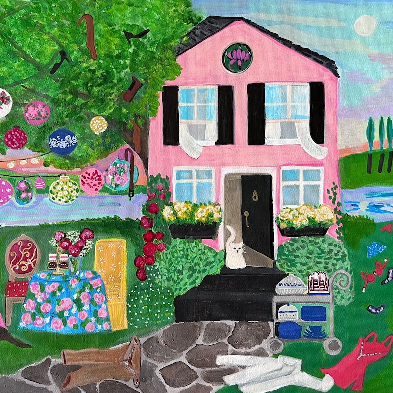 May include: A whimsical painting of a pink house with black shutters and a black door. A white cat sits on the steps. The yard features a stone path, a table with a floral tablecloth, and decorative hanging lanterns.
