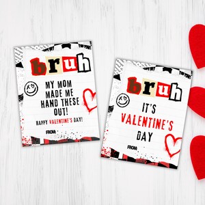 May include: Two Valentine's Day cards with a grunge aesthetic. The cards feature the word "bruh" in large, bold letters and a red heart. The text on the cards reads "My mom made me hand these out! Happy Valentine's Day!" and "It's Valentine's Day!"