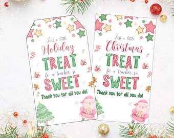 May include: Two printable gift tags with a Christmas theme. The tags are white with a pink and green border. The text on the tags reads "Just a little Holiday Treat for a teacher so sweet" and "Just a little Christmas Treat for a teacher so sweet". The tags also feature a cartoon Santa Claus and a Christmas tree.