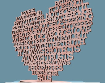 May include: A wooden heart-shaped cutout with the words "Love is patient, love is kind, it does not envy, it does not boast, it is not proud, it is not self-seeking, it is not easily angered, it keeps no record of wrongs, it does not delight in evil but rejoices with the truth, it always protects, always trusts, always hopes, always perseveres, love never fails" inscribed on it.