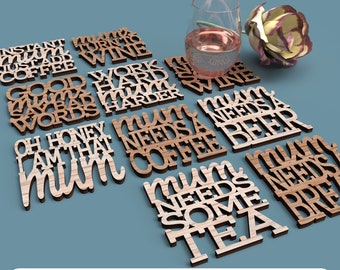 May include: A set of 10 laser cut wooden coasters with various humorous sayings about needing coffee, wine, beer, and tea. The coasters are made of light and dark wood and feature a variety of fonts and styles.