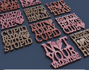 May include: A set of 10 laser cut wood designs with Valentine's Day themed sayings. The designs are in various shades of brown and pink with a broken heart graphic on most of them. The sayings include "Anti Love Potion", "Chasing Dreams Not Hearts", "Cupid's Arrow Missed Me", "Single & Ready to Stay Single", "Love is a Trap", "Cupid Rhymes with Stupid", "Not Today Cupid", "Broken Hearts Club", "Not Your Valentine", and "Cheers to My Heart".
