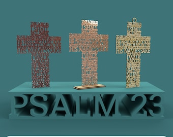 May include: Three wooden crosses with the words of Psalm 23 engraved on them. The crosses are standing on a wooden platform with the words "PSALM 23" carved into it. The crosses are a light brown color and the words are a darker brown color.
