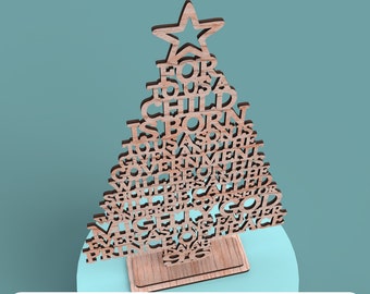 May include: Wooden Christmas tree decoration with a star on top, cut out with words. The tree sits on a rectangular base. The words "FOR TO US A CHILD IS BORN" are visible. The bottom of the image reads "DIGITAL FILE FOR LASER CUTTING".