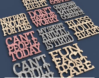 May include: A collection of laser-cut wooden signs with various phrases, including "We Can't Both Be Right" and "Don't Worry, Be Happy." The signs are in different colors and fonts, with the text "Digital File for Laser Cutting" at the bottom.