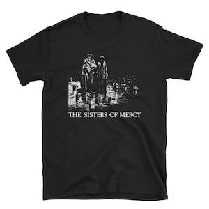 May include: Black t-shirt with a white graphic of two figures standing in front of a building. The text "THE SISTERS OF MERCY" is printed below the graphic.