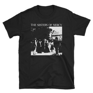 May include: Black t-shirt with a white graphic print of a band called "The Sisters of Mercy". The graphic shows four figures walking in front of a building.