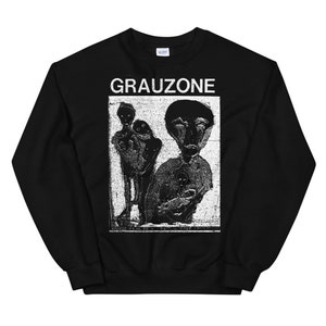 May include: Black sweatshirt with a white graphic print of a band called "GRAUZONE". The graphic features a black and white image of three people.