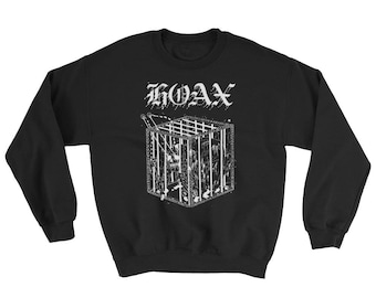 May include: Black sweatshirt with a white graphic of a cage with the word "HOAX" above it.