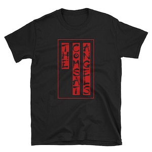 May include: Black t-shirt with a red rectangle containing the text "THE COMSAT ANGELS" in a stylized font.