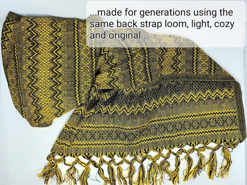 May include: A woven textile featuring a repeating geometric pattern in black and yellow. The fabric includes a fringed edge with twisted tassels. Text overlay reads: ...made for generations using the same back strap loom, light, cozy and original...