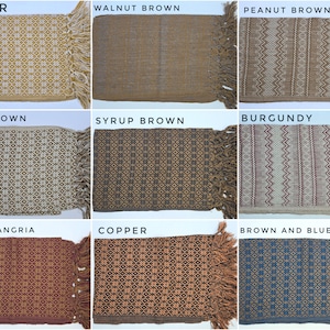 May include: A collection of nine rectangular woven textiles with fringe, each featuring distinct geometric patterns and colorways labeled as Ginger, Walnut Brown, Peanut Brown, Latte Brown, Syrup Brown, Burgundy, Brown Sangria, Copper, and Brown and Blue.